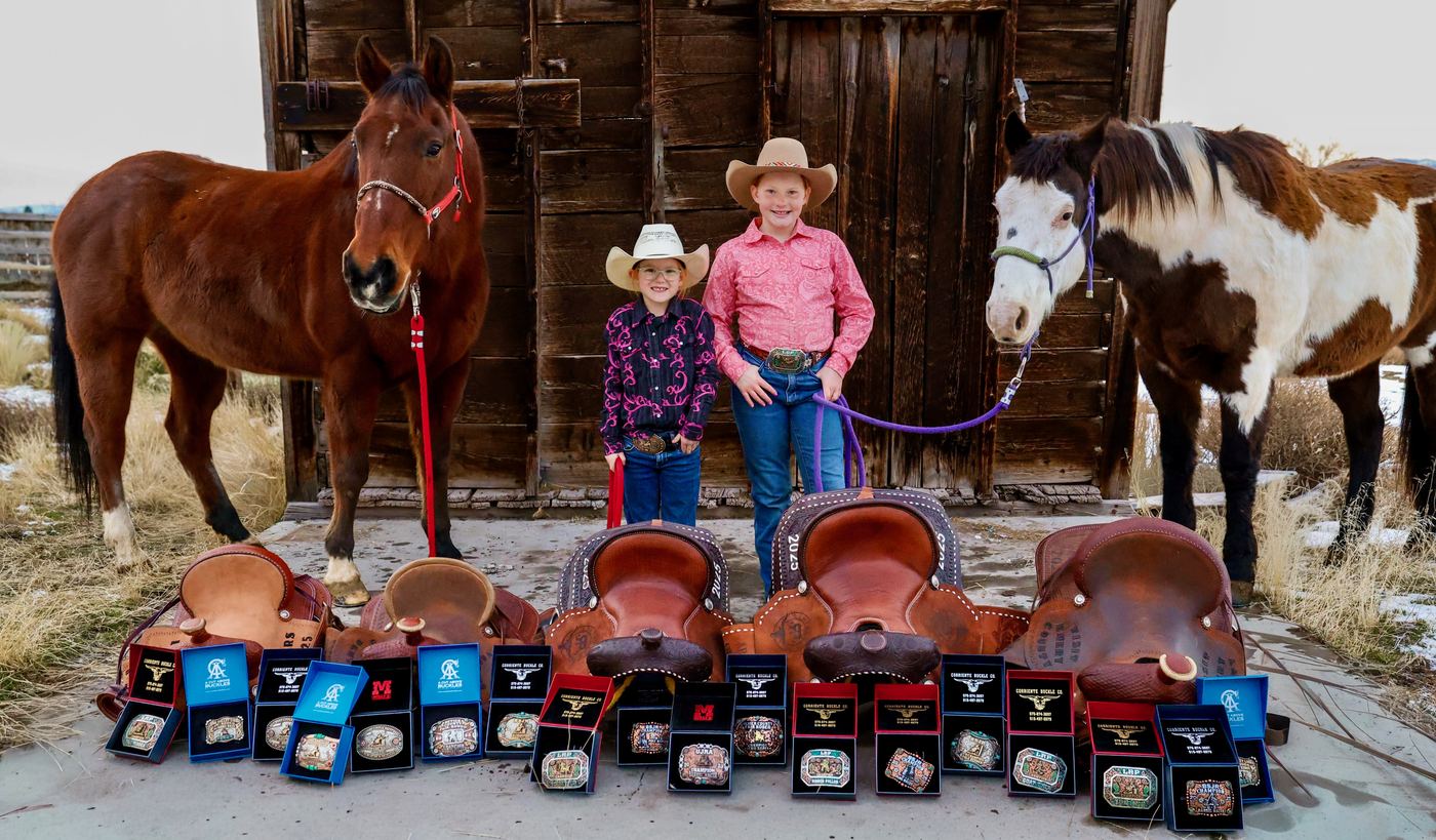 Dallie and Reinsley with their horses, saddles and buckles